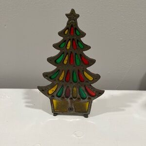 Vintage cast iron and glass Christmas tree has red green and gold color Glass